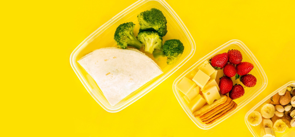 stock-photo-food-in-plastic-containers-ready-to-eat-from-above-to-take-away-on-yellow-background-healthy-food-1655778574.jpg